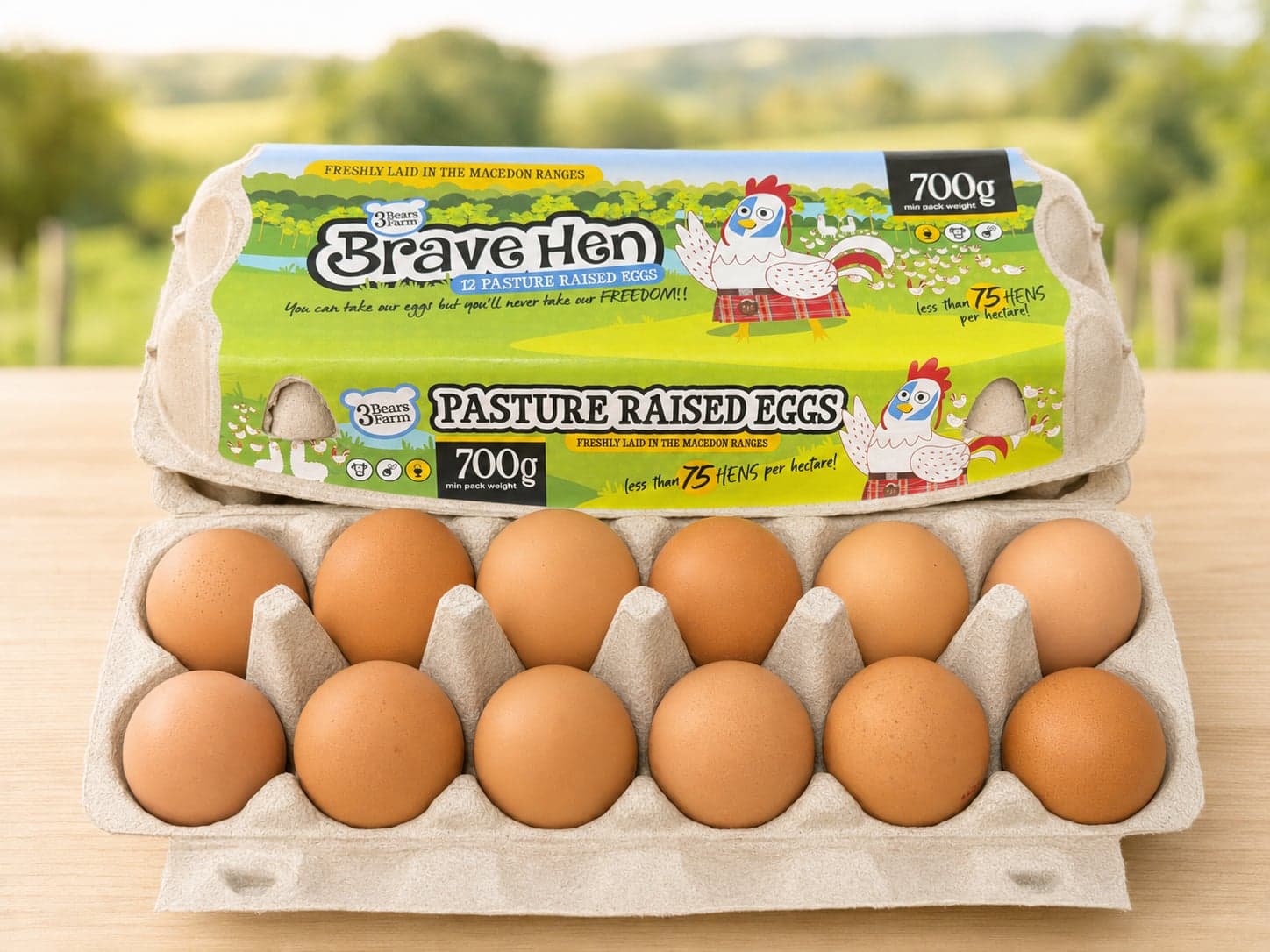 An open Brave Hen carton showing a dozen brown pasture-raised eggs